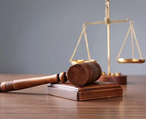 Symbol of law and justice in an empty courtroom, embodying the essence of the legal system. Ideal for those seeking law dissertation help, conveying a strong concept of justice and legal studies.